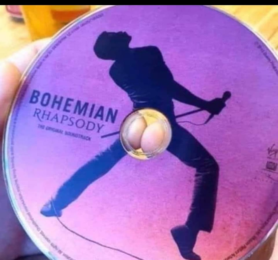 Funny meme. Image of Bohemian Rhapsody CD with fingers pressed together in middle of picture of Freddie Mercury to look like a butt.