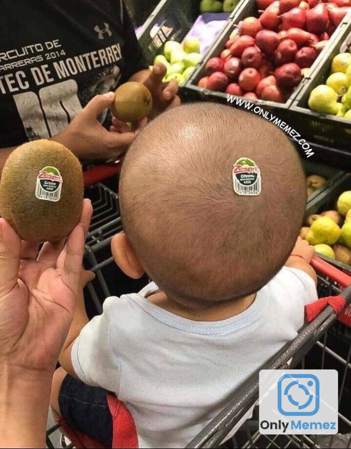 Funny meme of a baby next to a kiwi fruit. The baby has short hair like the kiwi fruit and has a kiwi fruit sticker on his head, making it look like the fruit.